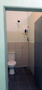a bathroom with a toilet and a shower at Langkawi-Village Mix Dormitory in Pantai Cenang