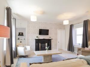 a living room with a couch and a fireplace at Mary Ann Villa in Inverness