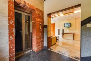 a glass door leading into a room with a hallway at FabHotel Shakthi Suites - Nr Jayadeva Hospital in Bengaluru +20 photos