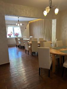 a dining room with a long table and chairs at Casa Mia in Braşov