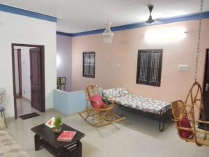 a living room with a couch and chairs at Aathira's 2 Bedroom house @ Heart of Coimbatore in Coimbatore