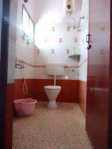 a bathroom with a toilet and a window and a tub at Aathira's 2 Bedroom house @ Heart of Coimbatore in Coimbatore
