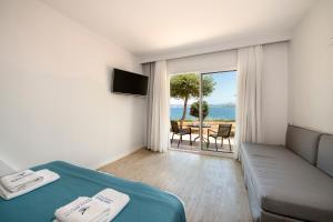 a bedroom with a bed and a view of the ocean at Balos Beach in Kissamos