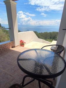 a table on a balcony with a view of the ocean at Sea View House, near Achilleio in Achílleion