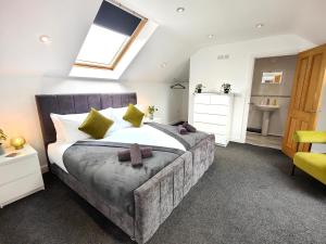 a bedroom with a large bed and a sink at Sanderson House in Cleator Moor
