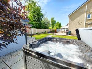 a hot tub in the backyard of a house at Sanderson House in Cleator Moor