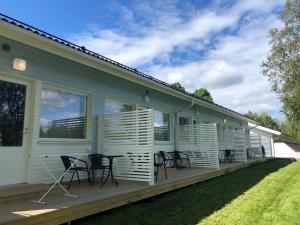 a deck with chairs and tables on a house at Arctic Resort Delight in Rovaniemi
