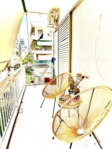 two chairs and a table on a balcony at SeaSide House 37 Θουκιδιδου,Alimos in Athens