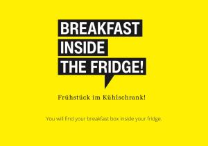 a yellow sign with the wordsbreakfast inside the bridge at ipartment Berlin Airport in Schönefeld