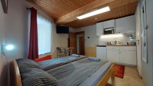 a large bed in a room with a kitchen at Das Eckhaus in Murau
