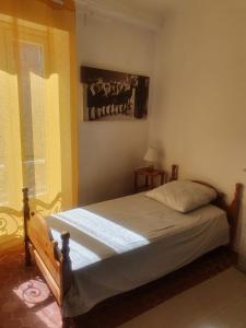 a bedroom with a bed and a window at La Baieta in Moulinet