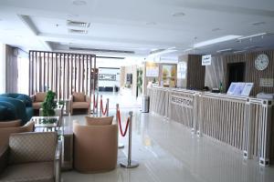un vestíbulo con sillas y mesas y un reloj en la pared en شقق نيروز ان للشقق المخدومة - Newroz N Serviced Apartments, en Riad