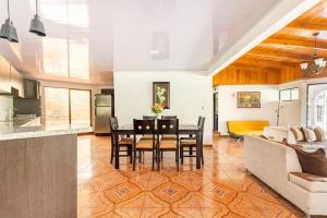 a living room with a table and a couch at Villa Dreams Irazu in Cartago