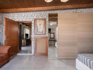 a room with a hallway with a door and a couch at Alkistis Sweet Homes in Stavros