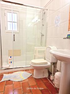 a bathroom with a shower and a toilet and a sink at 4 bedrooms house with sea view private pool and enclosed garden at Loule in Loulé
