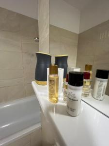 a bathroom with bottles of cosmetics on a counter at Apart Mihai Viteazu Residence in Braşov