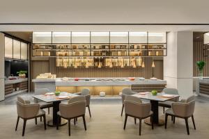 a rendering of a restaurant with tables and chairs at Citadines Qingshanhu Hangzhou in Hangzhou