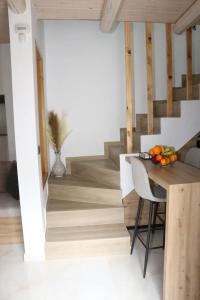 a kitchen with a table with a bowl of fruit on it at ELVIRA LUXURY APT in Hersonissos +12 photos