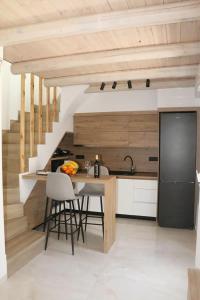a kitchen with a table and a black refrigerator at ELVIRA LUXURY APT in Hersonissos