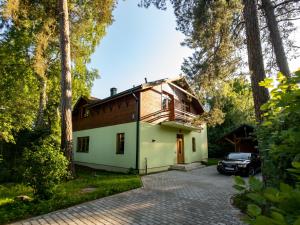 a house with a car parked in front of it at Your Seaside Villa in Jurmala in Jūrmala