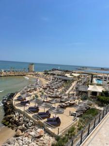an aerial view of a beach with umbrellas and the ocean at Sea Garden Beach Studio in Saints Constantine and Helena