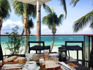 a table with food and a view of the ocean at WaterColors Boracay Dive Resort in Boracay