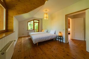 a bedroom with a bed and a wooden floor at Your Seaside Villa in Jurmala in Jūrmala