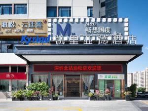 a building with a sign on the front of it at Kyriad Marvelous Hotel Shenzhen North Railway Station Yousong in Tiantangwei