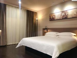 Katil atau katil-katil dalam bilik di Jinjiang Inn Select Zhenjiang Xijingdu Daxi Road
