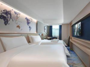 a hotel room with two beds and a map of the world at Kyriad Marvelous Hotel Shenzhen Guangming Zhenmei Subway Station in Bao'an +11 photos