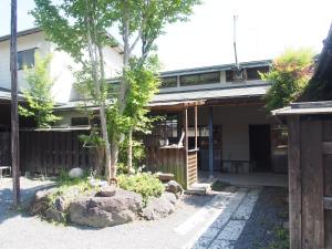 a house with a tree in front of it at Furuki in Mashiko