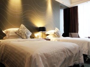 En eller flere senge i et værelse på Metropolo Hotel Zhenjia Wanda Plaza Railway Station