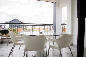 a dining room with a table and chairs on a balcony at 396 The Blyde Crystal Clear Lagoon 2 Bedroom Penthouse Apartment in Pretoria