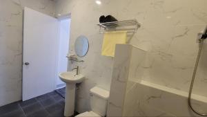 een badkamer met een wastafel, een toilet en een douche bij TuloMir #A 뚤로미르 행복한 4인실 in Moalboal