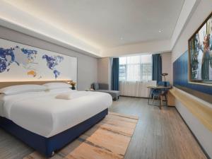 Letto o letti in una camera di Kyriad Hotel Baoying Jinyuan Square High-speed Railway Station