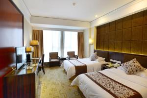 um quarto de hotel com duas camas e uma televisão em Vienna International Hotel Yangzhou Wanda Lippo Plaza em Yangzhou