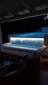a swimming pool at night with the lights on at Apartments Rafaj in Pula