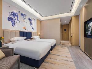 Letto o letti in una camera di Kyriad Hotel Baoying Jinyuan Square High-speed Railway Station