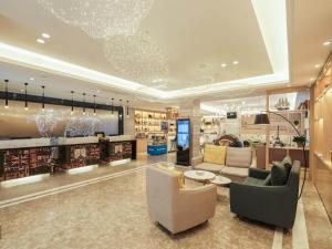 a library with couches and chairs in a store at Kyriad Marvelous Hotel Suzhou Guanqian Street and Shiquan Street in Suzhou