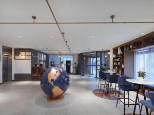 a room with a large blue globe on the floor at Kyriad Marvelous Hotel Shanghai Daning International Plaza in Shanghai