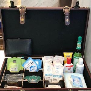 a black suitcase filled with different types of toiletries at Kyriad Marvelous Hotel Daya Bay BYD Technology Park in Huizhou