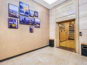 Campanile ShenZhen Longhua Dalang Business Centre في Lung Wa: غرفة مع باب مع صور على الحائط