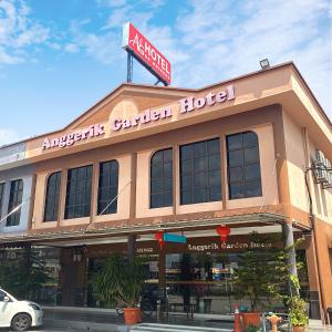 a building with a sign on top of it at Anggerik Garden Hotel - AG Hotel in Sitiawan