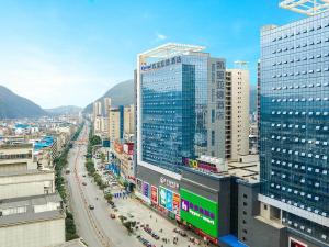 a city with many tall buildings and a street at Kyriad Marvelous Hotel Guilin Quanzhou in Quanzhou