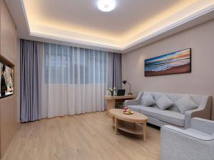 ein Wohnzimmer mit einem Sofa und einem Tisch in der Unterkunft Vienna hotel Hunan Shaoyang Longhui Bus Station in Longhui