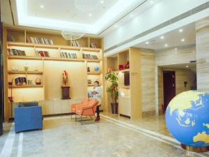a lobby with a ball in the middle of a room at Kyriad Marvelous Hotel Changsha Xiangya in Changsha