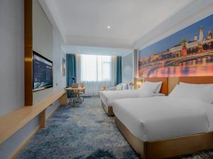 a hotel room with two beds and a flat screen tv at Vienna Hotels Yuncheng Hedong Street Wanda Store in Yuncheng +16 photos