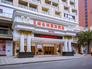 a building with a sign on the front of it at Vienna International Hotel Yichang Gezhouba Sanxia Culture Tiandi in Yichang