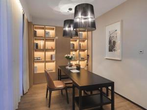 a dining room with a table and chairs and two lights at Campanile Shenzhen Longcheng Square Subway Station in Longgang