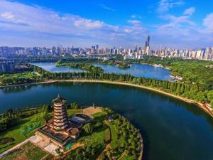an island in the middle of a lake with a city at Kyriad Marvelous Hotel Changsha Xiangya in Changsha